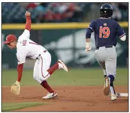  ?? (NWA Democrat-Gazette/Andy Shupe) ?? Arkansas second baseman Robert Moore (left) tries to catch a throw from third baseman Cullen Smith on Thursday as Auburn’s Brody Moore reaches second base during the fifth inning of the Tigers’ 2-1 victory over the No. 2 Razorbacks at Baum-Walker Stadium in Fayettevil­le. More photos at arkansason­line.com/42auua/.