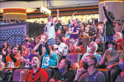  ??  ?? Football fans and gamblers react as the morning games unfold at the Sportsbook at Circa on Sunday.