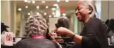  ?? — AFP ?? Jacqueline Robinson, who has done hair for the late Aretha Franklin, works on a customer at Salon Jacqueline &amp; Spa in Southfield, Michigan.