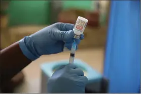  ?? (AP/Joseph Odelyn) ?? A medical worker prepares a shot of the Moderna vaccine during a vaccinatio­n campaign in July at Saint Damien Hospital in Port-au-Prince, Haiti. In late June, the internatio­nal system for sharing coronaviru­s vaccines sent about 530,000 doses to Britain, more than double the amount sent that month to the entire continent of Africa.