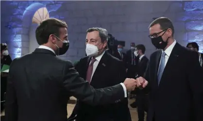  ?? ?? French president, Emmanuel Macron, fist bumps Poland’s prime minister, Mateusz Morawiecki, and Italy’s Mario Draghi during the opening ceremony of an EU summit in Porto, Portugal. Photograph: Reuters