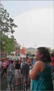  ?? PETE BANNAN – DIGITAL FIRST MEDIA ?? As Alisha Jones, president and chief executive officer of La Communidad Hispana of Kennett Square, spoke a rainbow appeared Sunday night at courthouse protest.