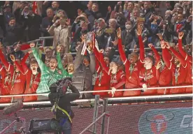  ?? ?? ABOVE: Jurgen Klopp and his Liverpool players celebrate beating Chelsea in the Carabao Cup final on Sunday, 25 March. BELOW: Jurgen Klopp inspired the end of Liverpool's 30-year wait for a league title in 2020.