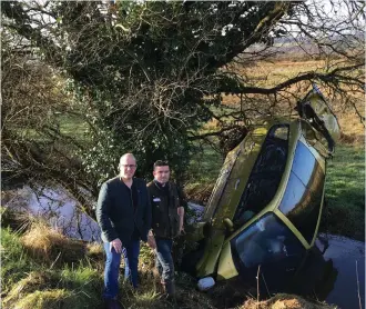  ??  ?? Councillor Chris MacManus at the scene of the latest crash where a car ended up in a drain.