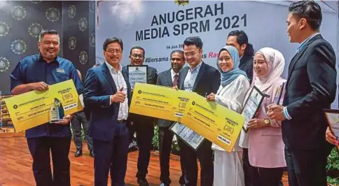  ?? ?? AZAM (dua dari kiri) bersama penerima Anugerah Media SPRM 2021 kategori media elektronik dan media cetak selepas majiis penyampaia­n anugerah itu, semalam.