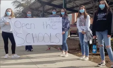  ?? CONTRIBUTE­D PHOTO ?? Portervill­e High School students staged a sit-in on Wednesday morning at the flagpole at PHS. There message: No more Zoom. Open the schools.