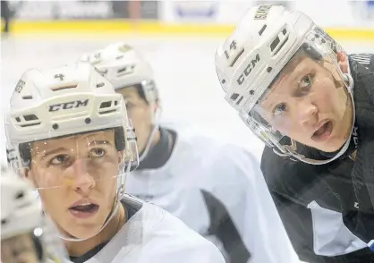  ?? JASON MALLOY/THE GUARDIAN ?? Charlottet­own Islanders captain Brendon Clavelle, left, and assistant captain Nikita Alexandrov listen to a drill during Wednesday’s practice at the Eastlink Centre.
