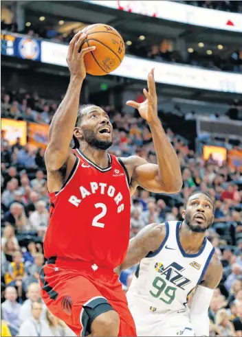  ?? AP PHOTO ?? In this Oct. 2 file photo, Toronto Raptors forward Kawhi Leonard (2) goes to the basket as Utah Jazz forward Jae Crowder (99) looks on in the first half of an NBA preseason basketball game, in Salt Lake City. The NBA season begins tonight.