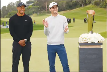  ?? Associated Press ?? Niemann wins title: Joaquin Niemann, of Chile, right, stands next to Tiger Woods on the 18th green after winning the Genesis Invitation­al golf tournament at Riviera Country Club, on Feb. 20, 2022, in the Pacific Palisades area of Los Angeles.