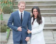  ?? — AFP ?? Prince Harry and Meghan Markle pose for a photograph in the Sunken Garden at Kensington Palace in west London on Monday, following the announceme­nt of their engagement.