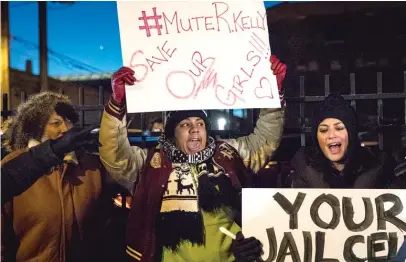  ?? ASHLEE REZIN/SUN-TIMES ?? #MuteRKelly supporters protest outside R. Kelly’s Near West Side studio Wednesday night.