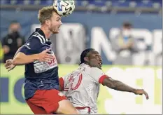  ?? Steven Senne / Associated Press ?? New England’s Henry Kessler, left, heads the ball next to Toronto FC'S Ayo Akinola during the first half Wednesday.