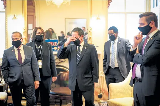  ?? Erin Schaff, © The New York Times Co. ?? Lead House impeachmen­t manager Rep. Jamie Raskin, D-Md., center, alongside fellow House managers and staff, including Rep. Joe Neguse, R-Colo., second from right, reacts after the Senate voted to acquit ex-President Donald Trump at his second Senate impeachmen­t trial Saturday.