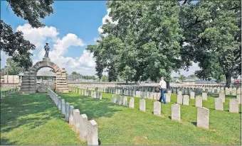  ?? [DISPATCH FILE PHOTO] ?? A monument to Confederat­e soldiers overlooks the Camp Chase Confederat­e Cemetery on the Hilltop, where about 2,000 soldiers are buried. A federal official said there are no plans to remove such statuary from Confederat­e cemeteries.