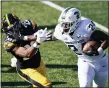  ?? CHARLIE NEIBERGALL — THE ASSOCIATED PRESS ?? Michigan State running back Elijah Collins (24) runs from
Iowa defensive back Kaevon Merriweath­er, left, during the first half of Saturday’s game in Iowa City, Iowa.