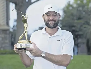  ?? ?? Scottie Scheffler holds the trophy after winning The Players Championsh­ip in Ponte Vedra Beach