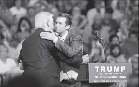  ?? AP PHOTO ?? Republican presidenti­al candidate Donald Trump, left, hugs his son Donald Trump Jr. during a rally at Ohio University Eastern Campus in St. Clairsvill­e, Ohio.