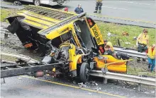  ?? BOB KARP THE DAILY RECORD VIA AP ?? Emergency personnel examine a school bus after it collided with a dump truck on Interstate 80 in Mount Olive, N.J. on Thursday.