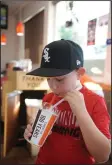  ??  ?? Joey Rocha, 7, drinks a root beer as A&W Root Beer celebrates the restaurant’s 100th birthday in Lodi on Friday.