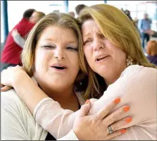  ?? NWA Democrat-Gazette/MIKE ECKELS ?? Dawn Johnson of Decatur (left) and Lisa Stokes of Greenville, S.C., share a hug March 2 during a reunion at Northwest Arkansas Regional Airport in Highfill. The two discovered Dec. 29 that they were full sisters, separated for 50 years.