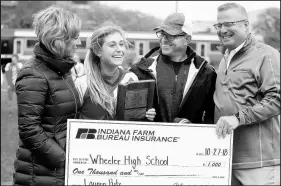  ??  ?? Wheeler’s Lauren Putz is awarded the Mental Attitude Award after the Class A state championsh­ip game Saturday.