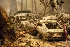  ?? AP PHOTO/NOAH BERGER ?? Following the Dixie Fire, scorched vehicles rest in a driveway in the Indian Falls community of Plumas County, Calif., on Monday, July 26, 2021.