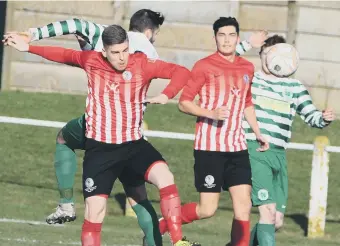  ??  ?? Silksworth CW (red) battle against league leaders Cleator Moor Celtic last month.