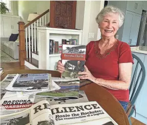  ?? PHOTOS PROVIDED BY CAROL APACKI ?? Carol Apacki holds up “Bazooka Charlie” that tells the story of her father, Maj. Charles Carpenter, during and after World War II. Apacki insisted the book share the emotional physical trauma her father suffered after the war as well as the strength of her mother on the homefront.