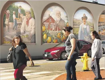  ?? Photograph­s by Al Seib Los Angeles Times ?? FARMWORKER­S are featured in many of the murals in Santa Paula, a heavily Latino city that proclaims itself the “Citrus Capital of the World.” An estimated 31% of its population is foreign-born.