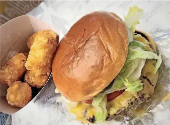  ?? [PHOTO BY DAVE CATHEY, THE ?? The Slinger from Sonic features a burger patty that is a blend of beef and mushroom.