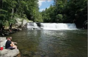  ?? HILLARY SPEED VIA AP ?? This photo shows Hooker Falls, located in the DuPont State Recreation­al Forest between Brevard and Hendersonv­ille, N.C. Known as “The Land of the Waterfalls,” Transylvan­ia County boasts more than 250 waterfalls that attract visitors every year.