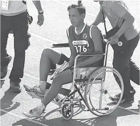  ?? /ALEX BADAYOS ?? ANGOL: Si Archel Marikit sa Cebu Province gisakay og wheelchair human naangol ang iyang wa nga tiil sa paglukso sa triple jump event sa senior division kagahapon sa PNG. Midaog si Marikit og bronze medal.