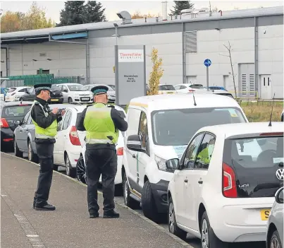  ?? Picture: Phil Hannah. ?? Wardens busy writing tickets in Auld Bond Rd in Perth on Wednesday.