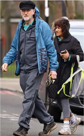  ??  ?? Having a bonfire, Jeremy? Mr Corbyn carries firelighte­rs as he heads to his London allotment with his wife yesterday
