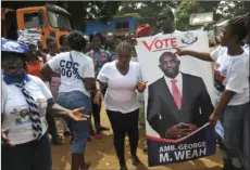  ??  ?? Supporters of former soccer player George Weah, Presidenti­al candidate for the Coalition for Democratic Change, celebrate, in Monrovia, Liberia, Friday. The National Election Commission has declared George Weah president-elect and Jewel Howard-Taylor...