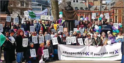  ?? ?? MARCH: Demonstrat­ors pose by the statue of suffragist Millicent Fawcett in Parliament Square in London yesterday