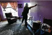  ?? Elizabeth Conley / Houston Chronicle ?? Community organizer Alain Cisneros easily puts his hand through a soaked wall in an apartment that was damaged by Tropical Storm Harvey.