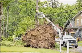  ??  ?? Line crews with Central Hudson work on Mansion Street to repair electrical lines and restore power to businesses and homes.