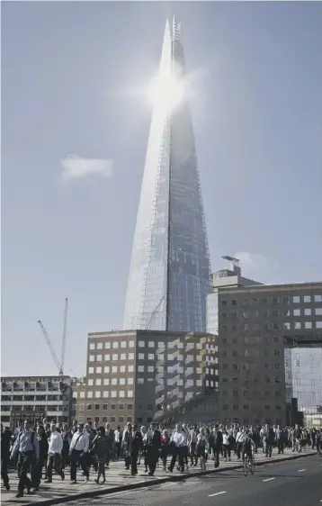  ?? PICTURES: SWNS ?? 0 As London commuters passed by unaware, a lone ‘free climber’ was climbing the Shard, one of Europe’s tallest buildings at more than 1,000ft