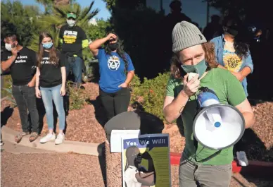  ?? DAVID WALLACE/THE REPUBLIC ?? Jacob Cordas, an organizer with One Fair Wage, speaks during a rally in front of Sen. Kyrsten Sinema's office in Phoenix on Monday. Those who attended the rally called for the minimum wage to increase to $15 per hour.