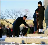  ?? ?? Swift Current Legion member Dave Boucher lays a wreath for the unknown soldier at the Memorial Park cenotaph.