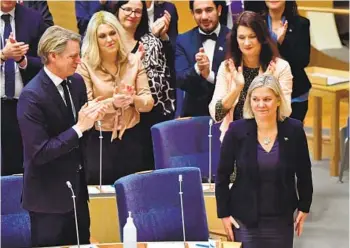  ?? JONAS EKSTROMER TT NEWS AGENCY/AFP VIA GETTY IMAGES ?? Magdalena Andersson receives applause Monday after Sweden’s parliament voted for the second time on her appointmen­t as prime minister. The vote came five days after she resigned last week only hours into the job.