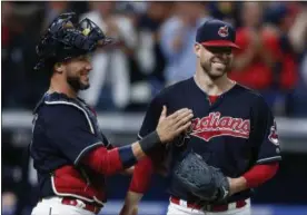  ?? ASSOCIATED PRESS FILE ?? Indians starting pitcher Corey Kluber, right, and catcher Yan Gomes celebrate a 2-0 victory over the Detroit Tigers earlier this month in Cleveland.