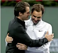  ?? — AFP ?? Tommy Haas is congratula­ted by Roger Federer after officially announcing his retirement.