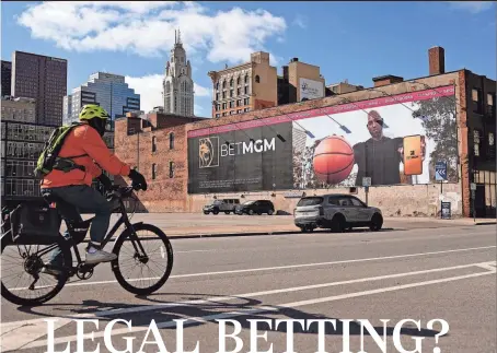  ?? ADAM CAIRNS/ COLUMBUS DISPATCH ?? Sports betting has been legal in the Buckeye State since Jan. 1, and ads like the one above at Spring and Third streets in Downtown Columbus have popped up all over Ohio in addition to heavy TV advertisin­g. However, just days after it became legal to bet on sports in Ohio, Gov. Mike Dewine criticized some companies, saying they were illegally advertisin­g to people younger than 21.