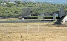  ?? Pictures: THEMBINKOS­I DWAYISA and TEBOGO LETSIE ?? TURFED OUT: The R4.2-million state-of-the-art sports complex near President Jacob Zuma’s Nkandla homestead, left, has been closed to local schools — and cattle, some of them belonging to the president, now use the soccer pitch as pasture