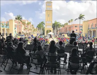  ?? JORDAN VERDADEIRO / SPECIAL TO THE POST ?? Members of the Youth Orchestra of Palm Beach play a concert April 30 at the Mizner Park Amphitheat­er in Boca Raton.