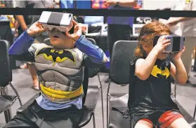 ?? Cody Glenn / Special to The Chronicle ?? At the Silicon Valley Comic Con, Arbel Adiel, 5, and his sister Shiri Adiel, 3, view NASA virtual reality headsets to show them what astronauts see.