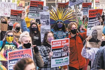  ?? Kerem Yucel / AFP via Getty Images ?? Demonstrat­ors march in Minneapoli­s, demanding justice at the trial of former police officer Derek Chauvin. He faces murder and manslaught­er charges in the death of George Floyd.