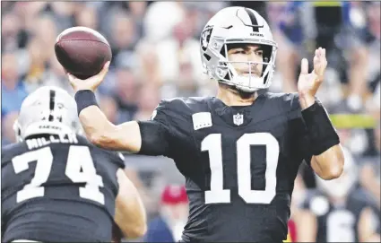  ?? AP PHOTO/DAVID BECKER ?? Las Vegas Raiders quarterbac­k Jimmy Garoppolo throws during the first half of an NFL football game against the Pittsburgh Steelers Sunday on Sept. 24 in Las Vegas.